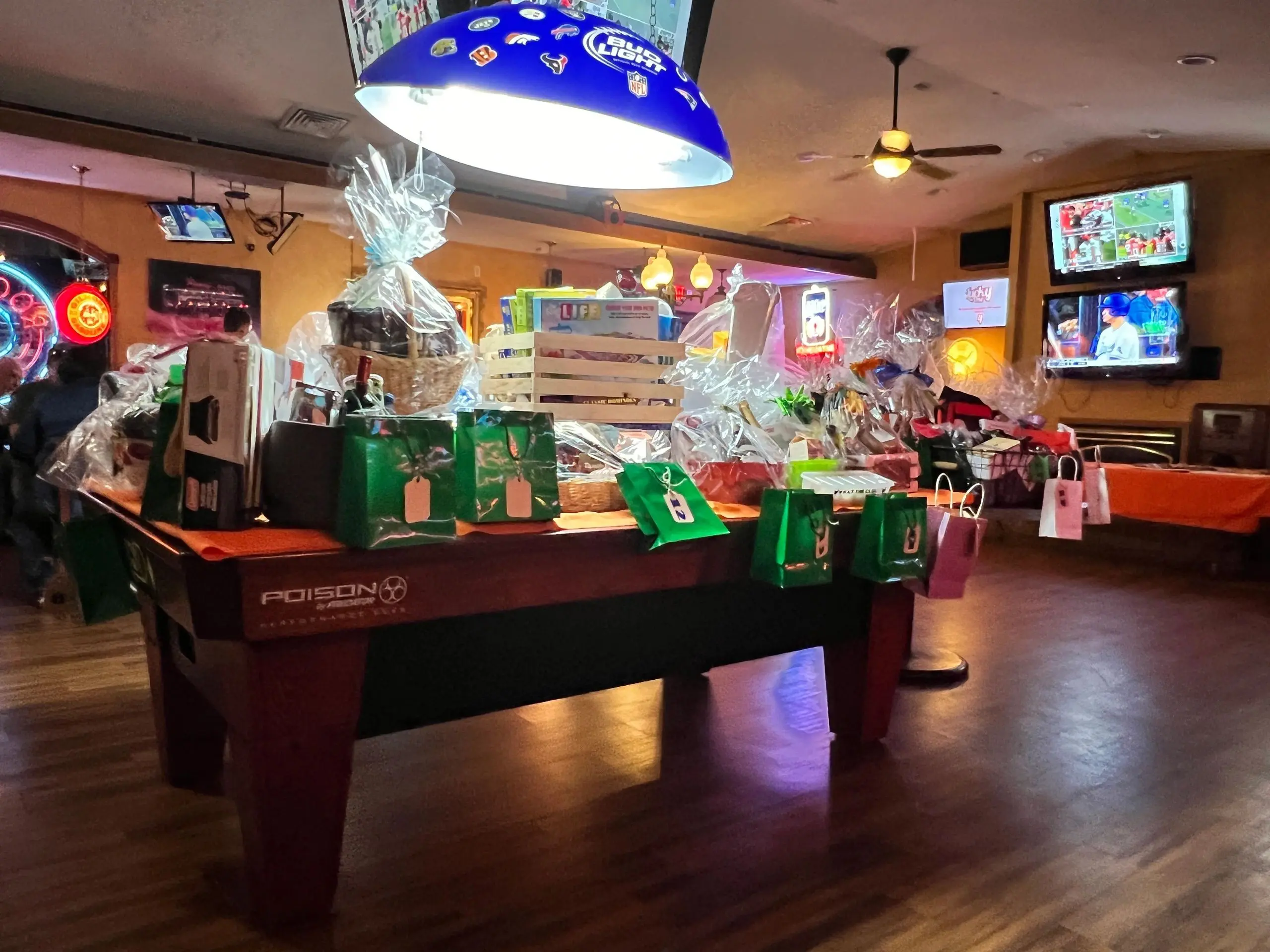 Billiards table covered in wrapped presents.