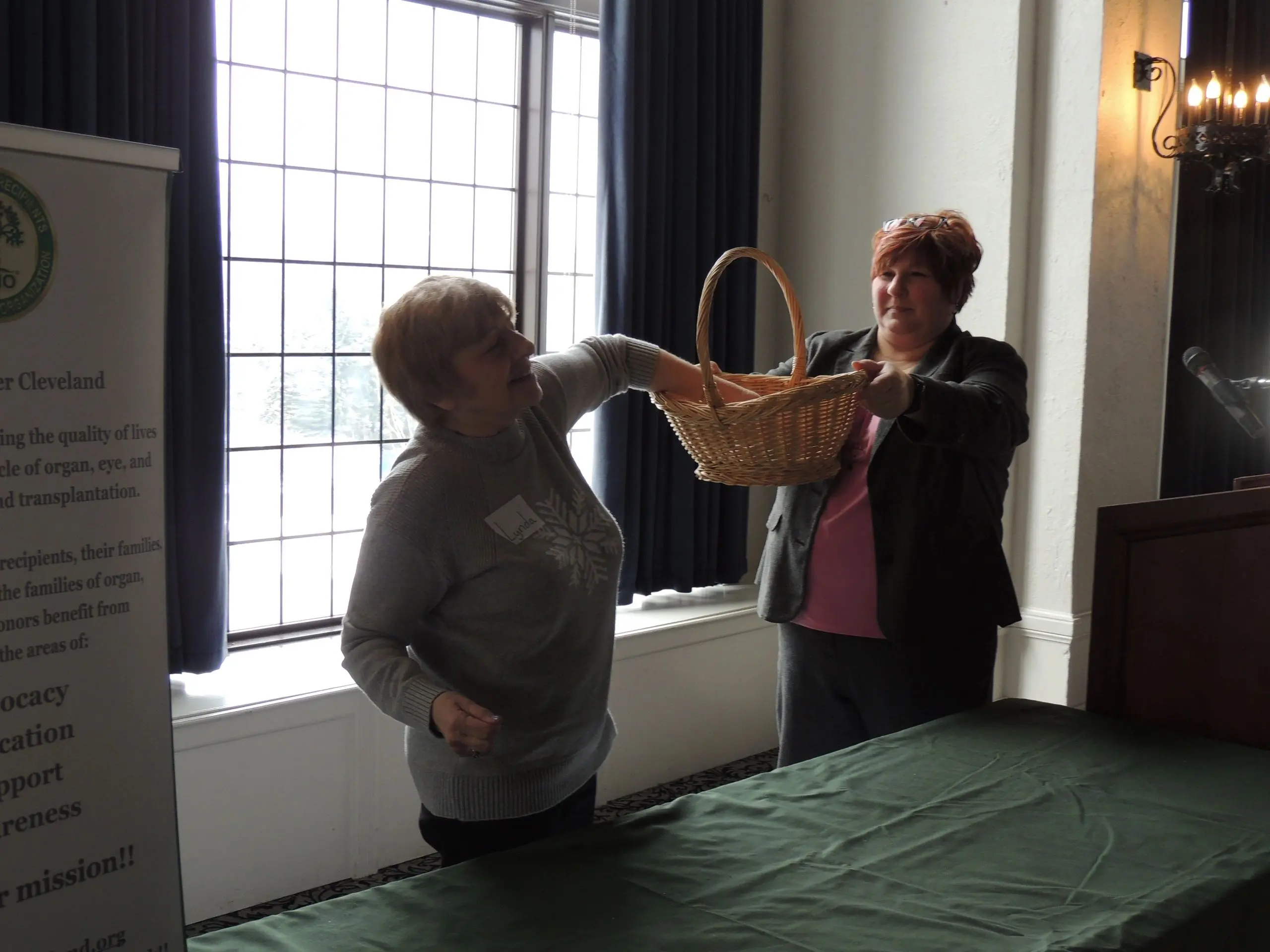 Two women holding a wicker basket