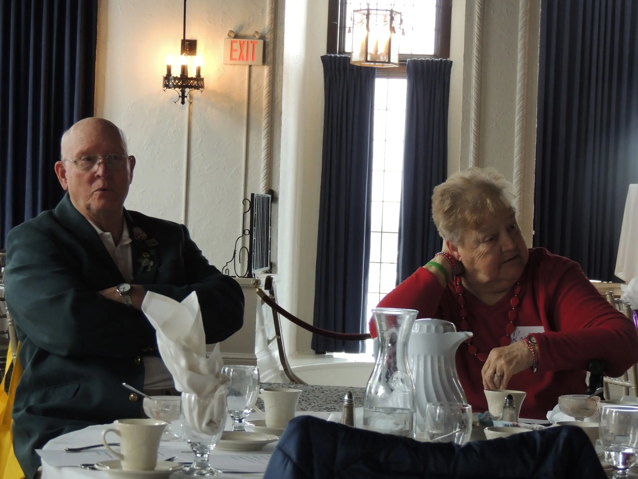 Elderly couple sitting at a dining table