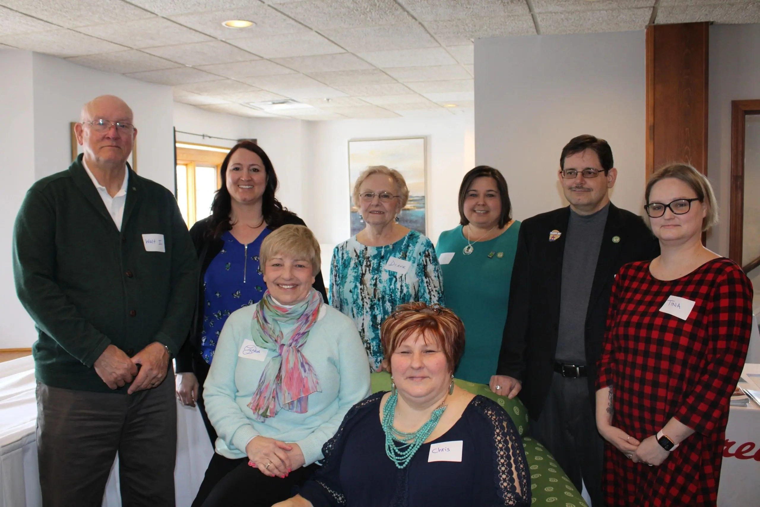 Seven adults gathered together indoors