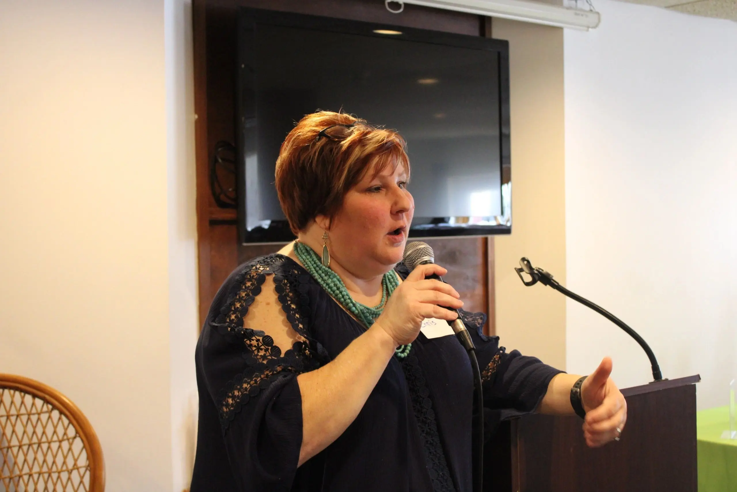 Woman giving a speech indoors.