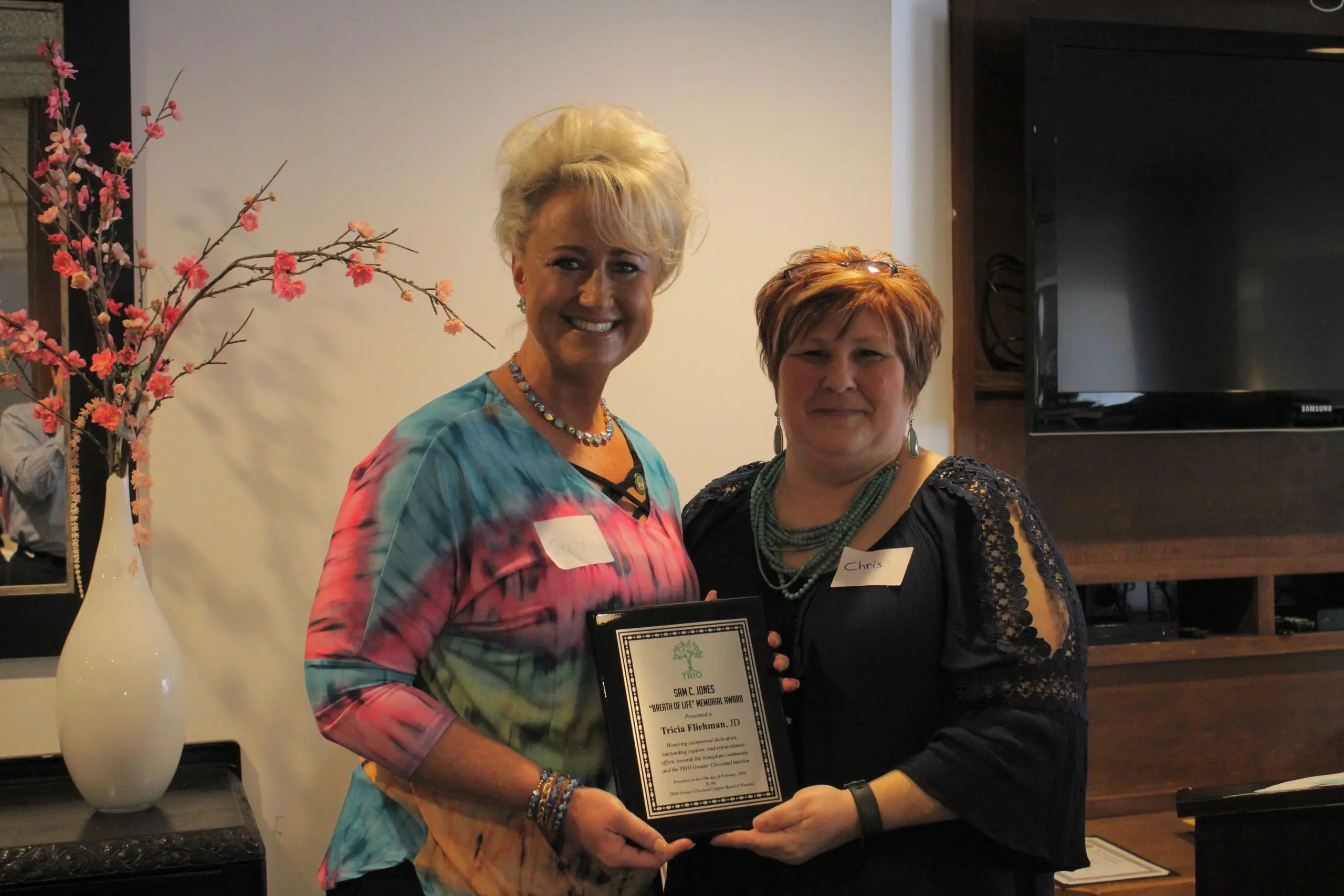 Two women holding an award plaque