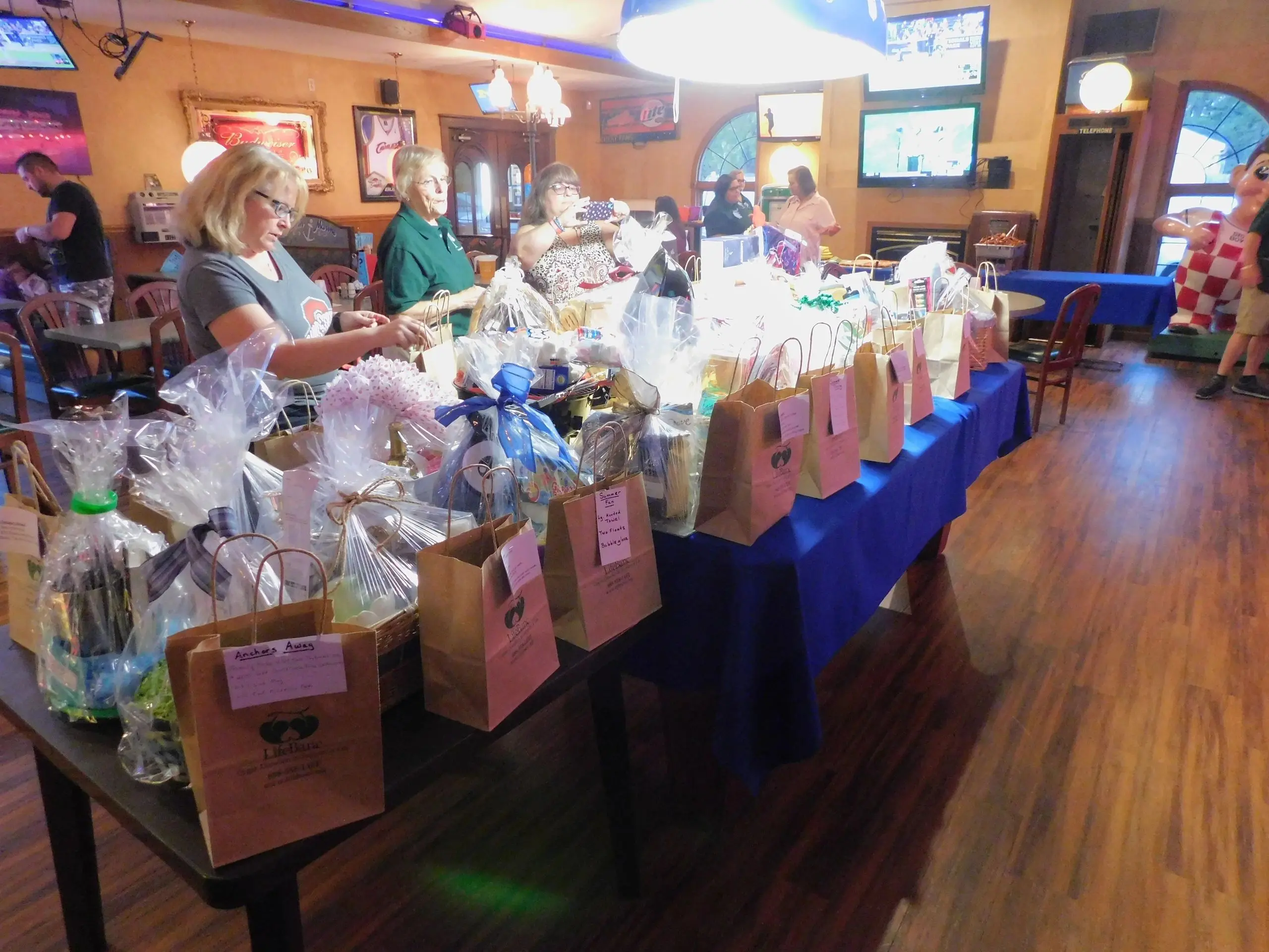 People browsing gift baskets in restaurant