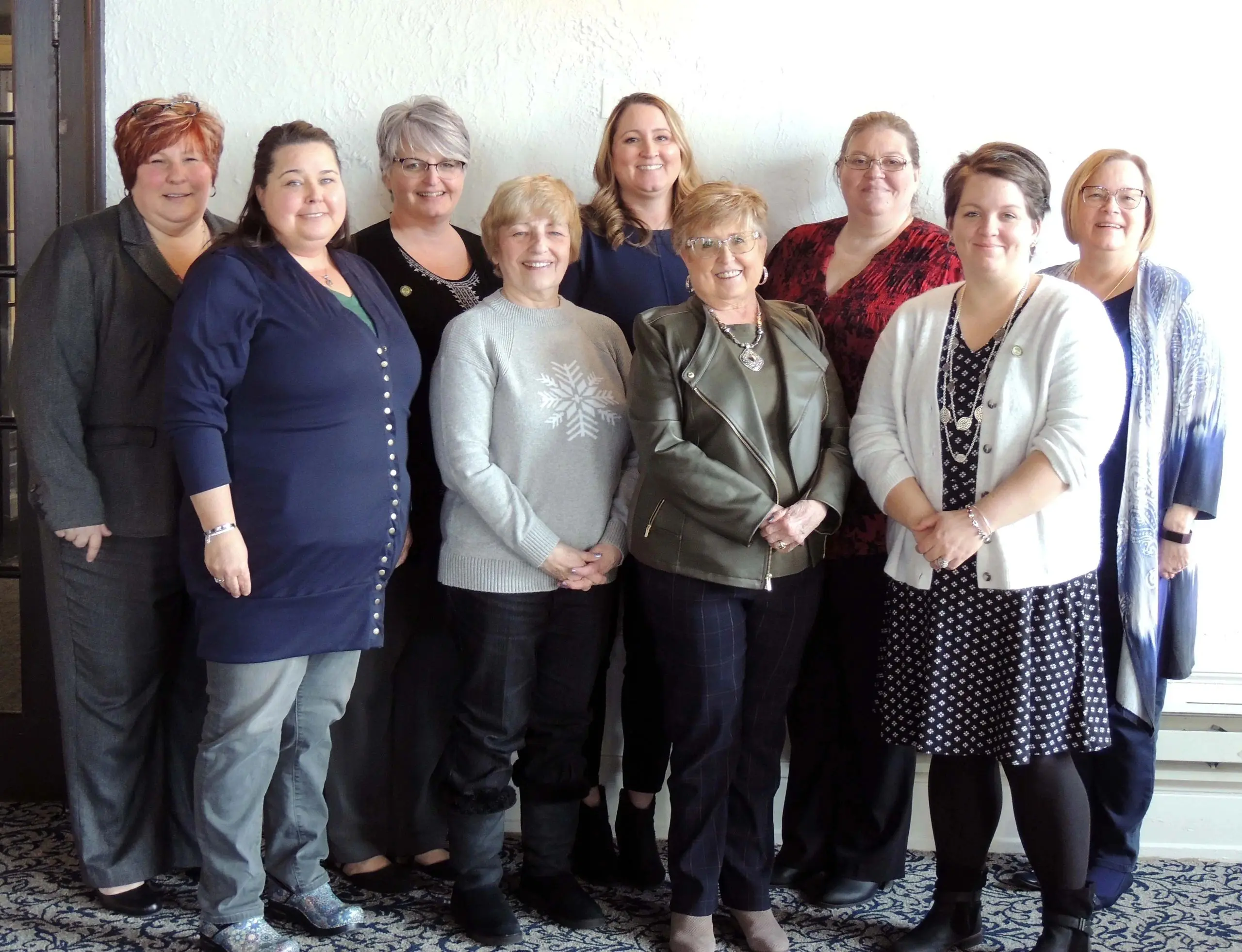 Group of women posing together indoors.