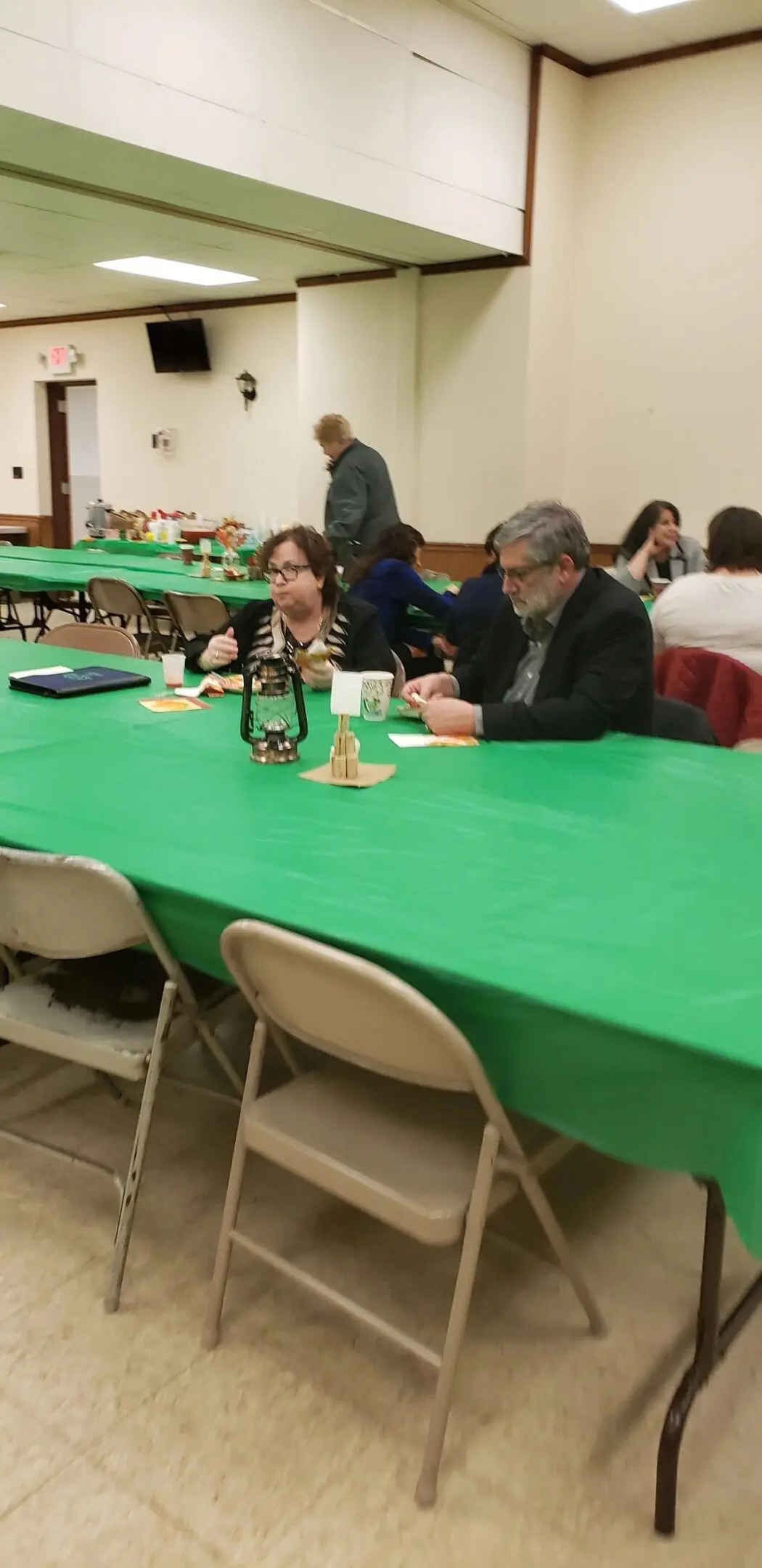 Group enjoying meal at long tables