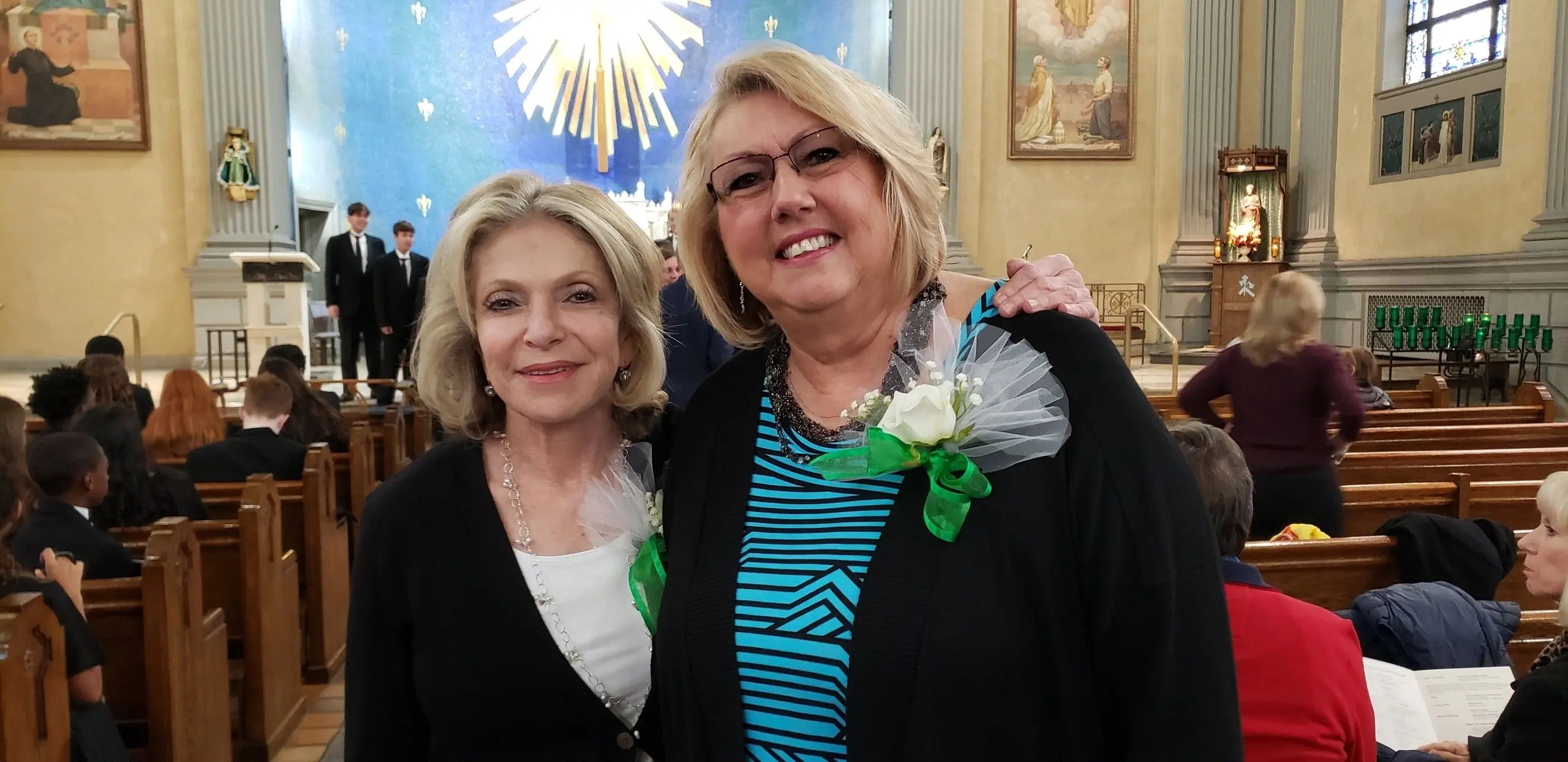 Two women smiling in a church