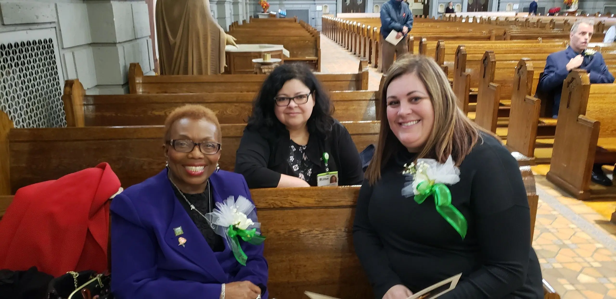 Women in church wearing floral corsages