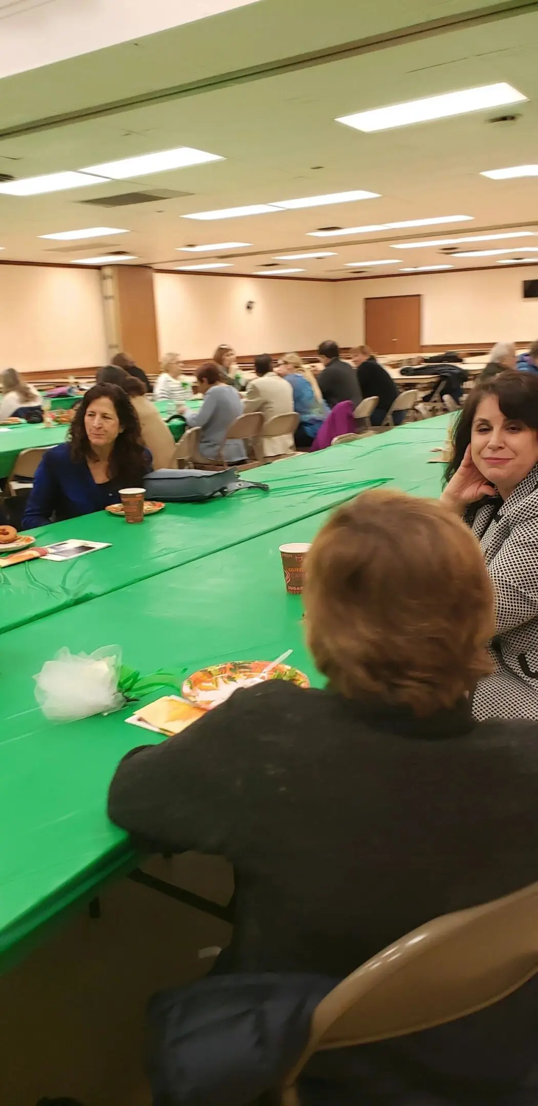 Community gathering with green tablecloth
