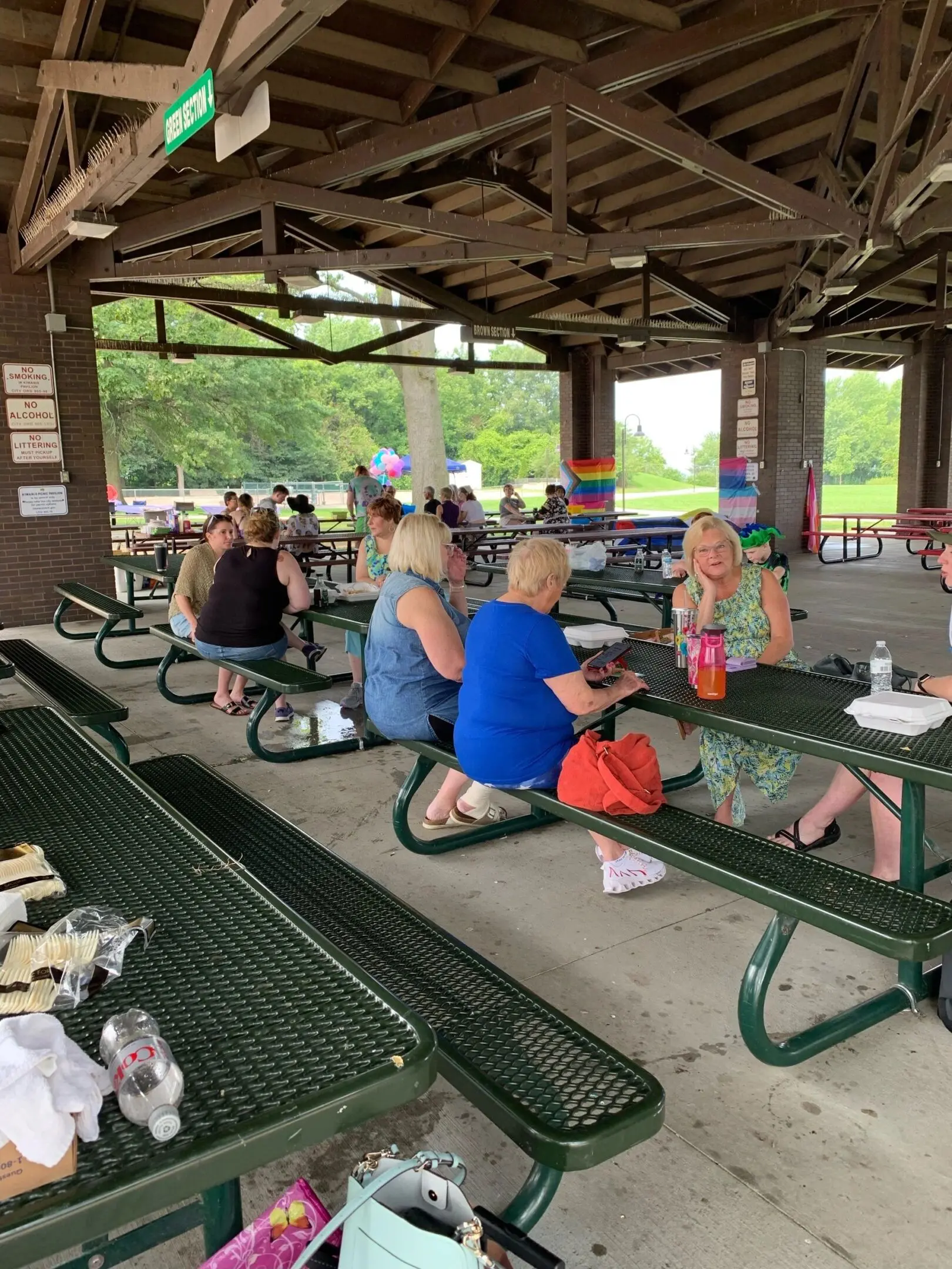 People gathered at a picnic shelter