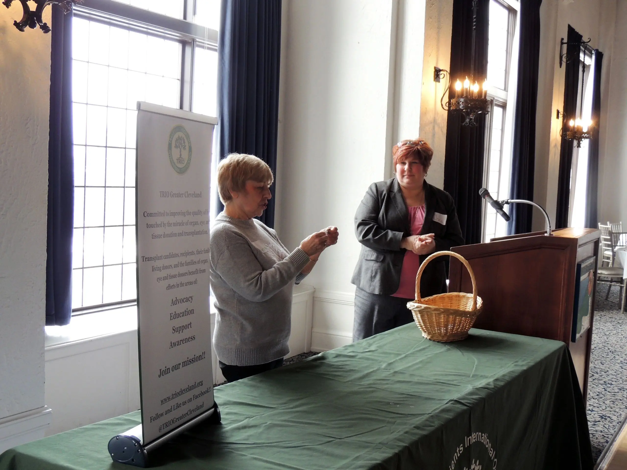 Two women speaking at a podium event