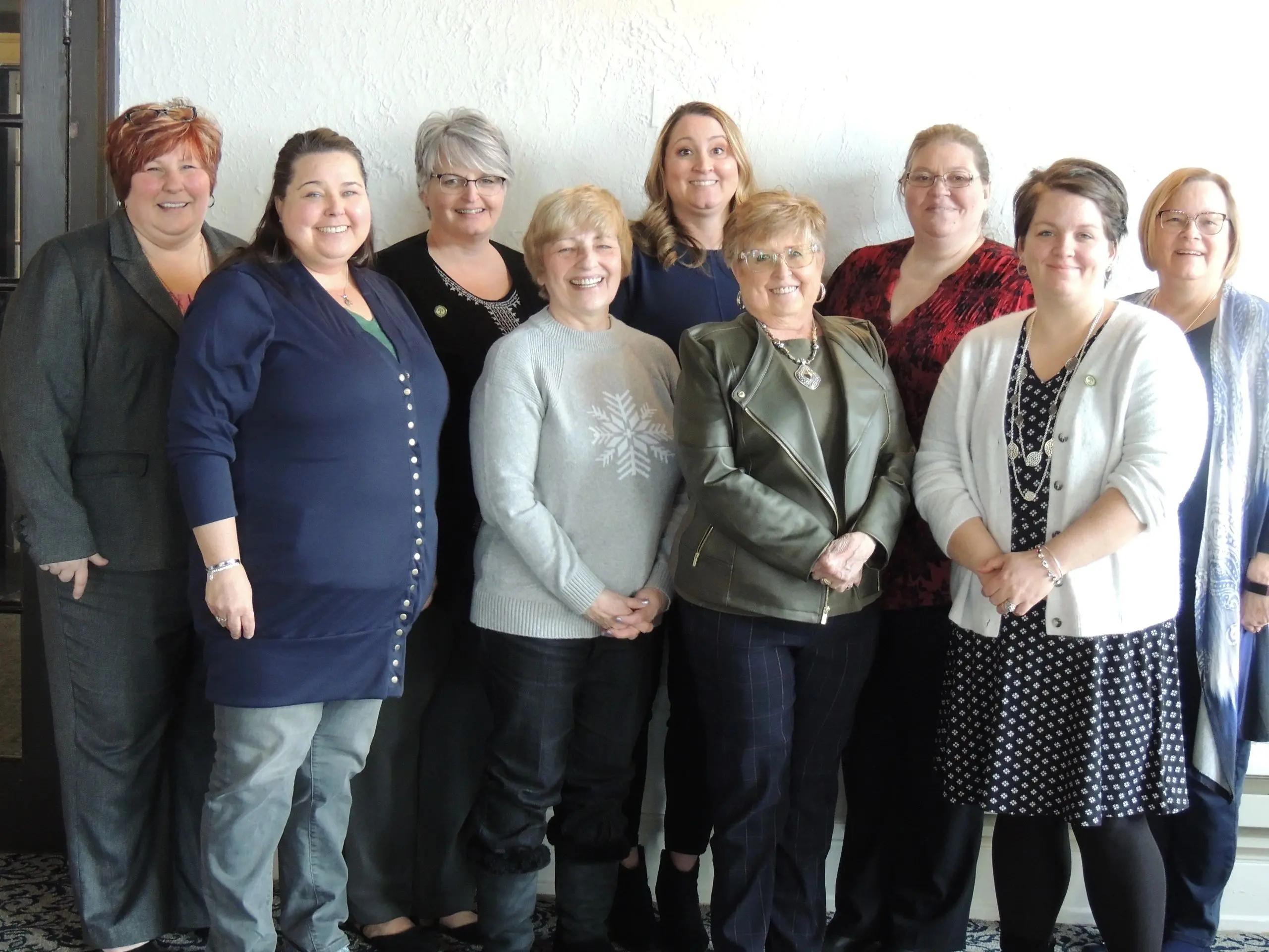 Women gathered for a group picture indoors