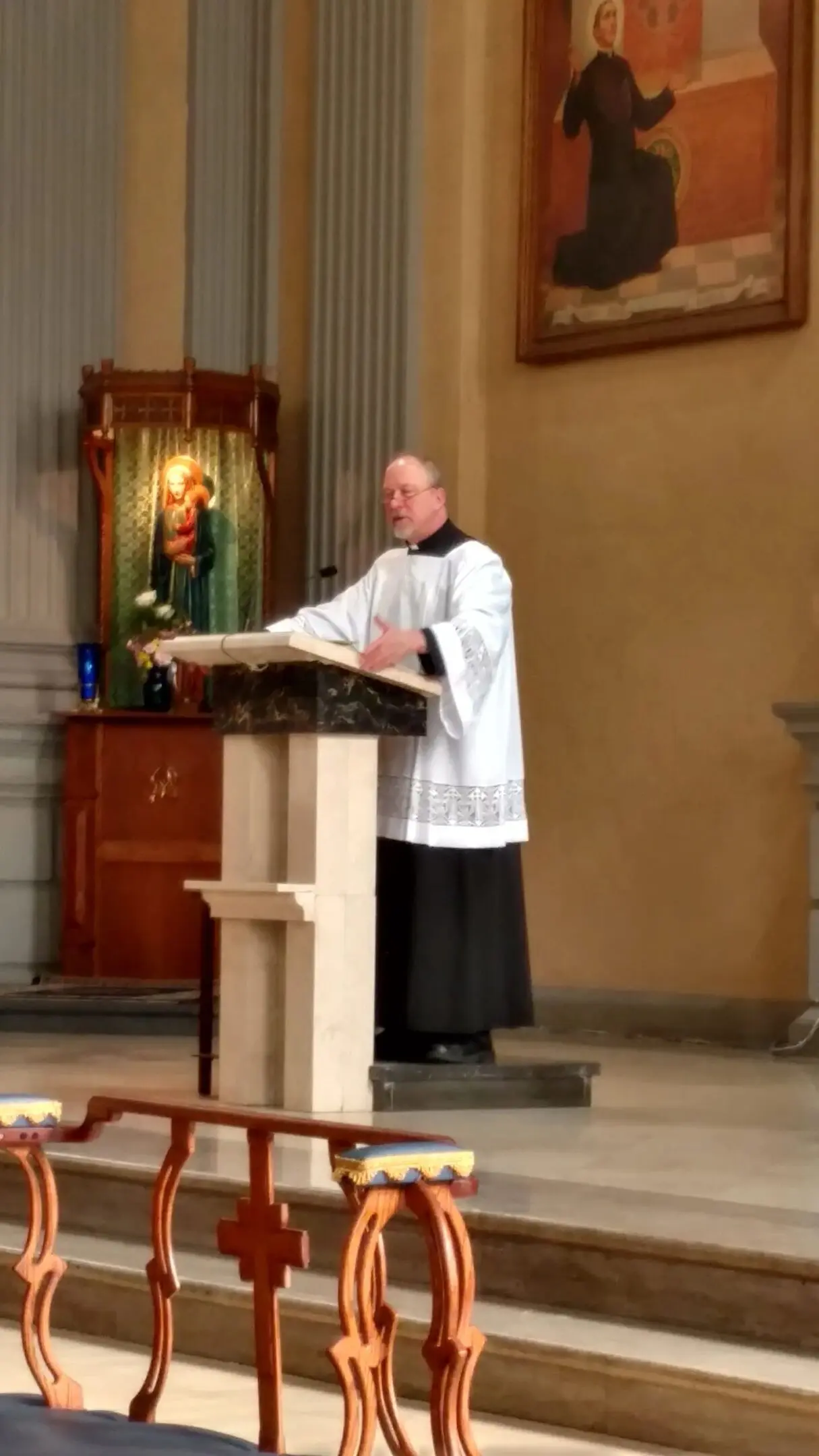 Priest delivering sermon in church