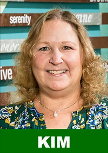 Smiling woman in floral shirt