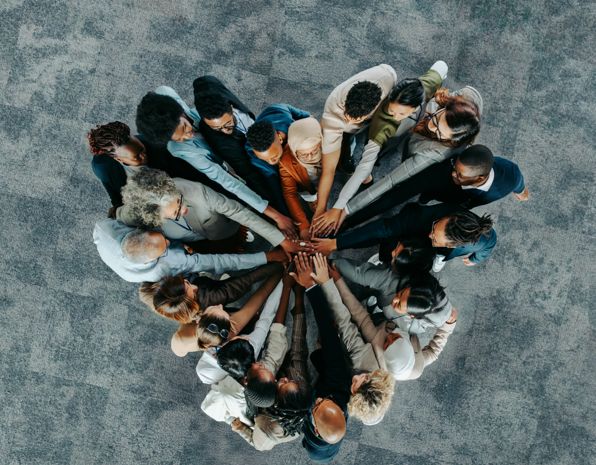 Overhead view of joined hands in unity