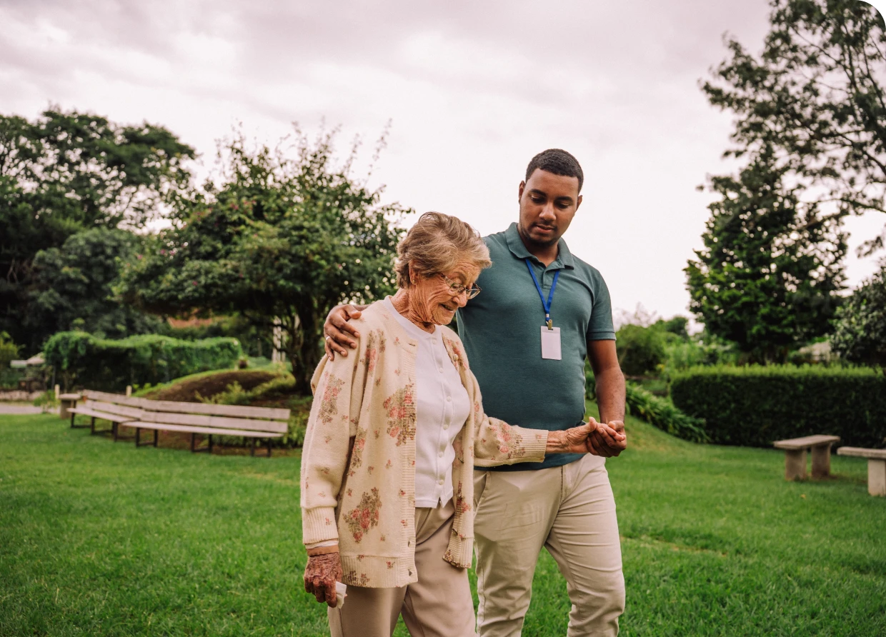 Senior woman and caregiver strolling outside
